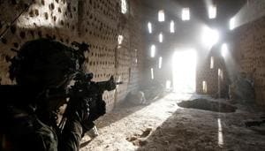 US soldier points his rifle at a doorway after coming under fire by the Taliban while on patrol in Zharay district in Kandahar province, southern Afghanistan on April 26, 2012.(REUTERS) US soldier points his rifle at a doorway after coming under fire by the Taliban while on patrol in Zharay district in Kandahar province, southern Afghanistan on April 26, 2012.(REUTERS)