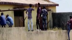 Men climb boundary wall of school in Yavatmal, pass chits to students during exam. (ANI photo) Men climb boundary wall of school in Yavatmal, pass chits to students during exam. (ANI photo)