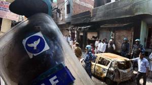 New Delhi, India - March 3, 2020: Rapid Action Force (RAF) personnel near a car burnt during last week’s violence that erupted in north-east Delhi over the Citizenship Amendment Act (CAA), at Shiv Vihar, in New Delhi, India, on Tuesday, March 3, 2020.(Raj K Raj/HT PHOTO) New Delhi, India - March 3, 2020: Rapid Action Force (RAF) personnel near a car burnt during last week’s violence that erupted in north-east Delhi over the Citizenship Amendment Act (CAA), at Shiv Vihar, in New Delhi, India, on Tuesday, March 3, 2020.(Raj K Raj/HT PHOTO)