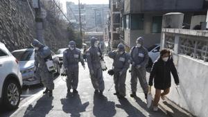 South Korean army soldiers spray disinfectant as a precaution against the coronavirus on a street in Seoul, on Thursday.(AP Photo) South Korean army soldiers spray disinfectant as a precaution against the coronavirus on a street in Seoul, on Thursday.(AP Photo)