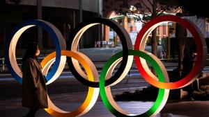 A woman wearing a protective face mask, following the outbreak of the coronavirus, walks past The Olympic rings in front of the Japan Olympics Museum in Tokyo, Japan.(REUTERS) A woman wearing a protective face mask, following the outbreak of the coronavirus, walks past The Olympic rings in front of the Japan Olympics Museum in Tokyo, Japan.(REUTERS)