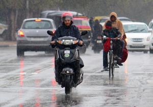Commuters caught in rain in Mohali on Friday. Commuters caught in rain in Mohali on Friday.