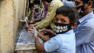 Students wearing facemasks wash their hands before attending a class at a governement-run high school in Secunderabad, the twin city of Hyderabad, on March 4, 2020, as part of health measures taken against the COVID-19 coronavirus outbreak. -(AFP photo) Students wearing facemasks wash their hands before attending a class at a governement-run high school in Secunderabad, the twin city of Hyderabad, on March 4, 2020, as part of health measures taken against the COVID-19 coronavirus outbreak. -(AFP photo)