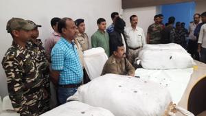 Murshidabad district’s superintendent of police AS Yadav (seated) is seen with the consignment of ganja that was smuggled to West Bengal from Assam.(HT Photo) Murshidabad district’s superintendent of police AS Yadav (seated) is seen with the consignment of ganja that was smuggled to West Bengal from Assam.(HT Photo)