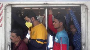 A passenger wearing a face mask as a prevention against Covid-19 travels with others in a local train in Mumbai, on Thursday.(AP Photo) A passenger wearing a face mask as a prevention against Covid-19 travels with others in a local train in Mumbai, on Thursday.(AP Photo)