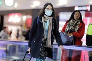 A traveller wearing a mask at the John F Kennedy International Airport in New York, US, amid coronavirus reports.(Reuters Photo) A traveller wearing a mask at the John F Kennedy International Airport in New York, US, amid coronavirus reports.(Reuters Photo)