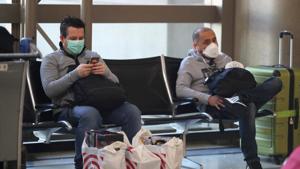 People wear masks at the international terminal at LAX airport in Los Angeles, California, US, amid reports of the coronavirus, on March 11.(Reuters Photo) People wear masks at the international terminal at LAX airport in Los Angeles, California, US, amid reports of the coronavirus, on March 11.(Reuters Photo)