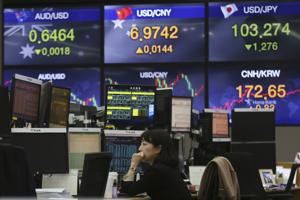 A currency trader watches monitors at the foreign exchange dealing room of the KEB Hana Bank headquarters in Seoul, South Korea on Thursday.(AP Photo) A currency trader watches monitors at the foreign exchange dealing room of the KEB Hana Bank headquarters in Seoul, South Korea on Thursday.(AP Photo)