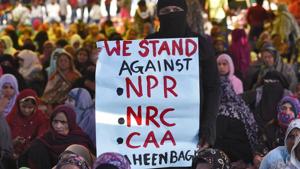 Women hold a placard during the ongoing sit-in protest against NPR, NRC and CAA.(Burhaan Kinu/HT photo)