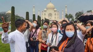 Tourist wear protective masks in wake of the deadly novel coronavirus, at Taj Mahal, in Agra.(PTI file photo)