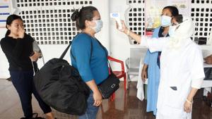 A doctor measures the temperature of a passenger using the thermal screening device in the wake of a novel Coronavirus (Covid-19) outbreak, at Guwahati Railway Station on Monday.(ANI Photo) A doctor measures the temperature of a passenger using the thermal screening device in the wake of a novel Coronavirus (Covid-19) outbreak, at Guwahati Railway Station on Monday.(ANI Photo)