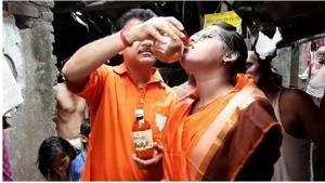 BJP leader Narayan Chatterjee feeding cow urine to a woman during an event in Kolkata on Monday.(HT Photo) BJP leader Narayan Chatterjee feeding cow urine to a woman during an event in Kolkata on Monday.(HT Photo)