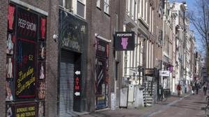 The narrow canal-side streets and alleys of Amsterdam's famed Red Light District, normally packed with tourists, were largely deserted.(AP) The narrow canal-side streets and alleys of Amsterdam's famed Red Light District, normally packed with tourists, were largely deserted.(AP)