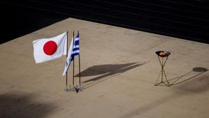 The Japanese national flag waves next to an altar with the Olympic flame of the Tokyo 2020 Summer Olympics(REUTERS) The Japanese national flag waves next to an altar with the Olympic flame of the Tokyo 2020 Summer Olympics(REUTERS)