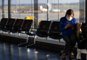 A woman with a protective face mask sits in the waiting area at Vienna International Airport in Schwechat, Austria March 16, 2020.(Reuters File Photo) A woman with a protective face mask sits in the waiting area at Vienna International Airport in Schwechat, Austria March 16, 2020.(Reuters File Photo)
