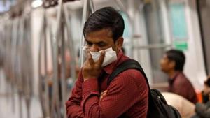 A commuter uses his handkerchief to cover his face as he travels by metro in NCR.(REUTERS PHOTO.) A commuter uses his handkerchief to cover his face as he travels by metro in NCR.(REUTERS PHOTO.)