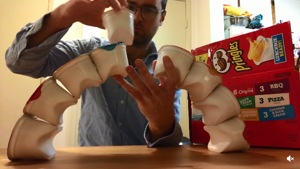 The image shows a man trying to make a structure with plastic containers.(Reddit/KLGAviation)