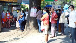 Ration shopkeepers distribute free rice to people at a government ration shop during the Covid-19 lockdown, in Kochi on Wednesday.(ANI Photo) Ration shopkeepers distribute free rice to people at a government ration shop during the Covid-19 lockdown, in Kochi on Wednesday.(ANI Photo)