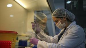 Wearing a protective suit, a research and development company employee works on the production of coronavirus testing kits in Gebze, northwestern Turkey, Monday, March 23, 2020.(AP) Wearing a protective suit, a research and development company employee works on the production of coronavirus testing kits in Gebze, northwestern Turkey, Monday, March 23, 2020.(AP)