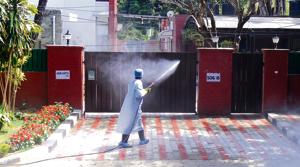 An MC worker sanitising the house of UT health secretary Arun Kumar Gupta whose daughter is under home quarantine in Sector 16, Chandigarh, on Sunday.(anil dayal/ht) An MC worker sanitising the house of UT health secretary Arun Kumar Gupta whose daughter is under home quarantine in Sector 16, Chandigarh, on Sunday.(anil dayal/ht)