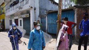 Police personnel wearing a protective outfit patrol Hindipidi area after a person tested postive for COVID-19, during a nationwide lockdown in the wake of the disease.(PTI Photo) Police personnel wearing a protective outfit patrol Hindipidi area after a person tested postive for COVID-19, during a nationwide lockdown in the wake of the disease.(PTI Photo)