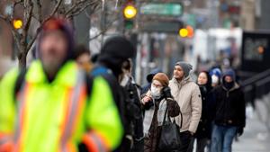 A woman adjusts her mask while she waits in line as the city's public health unit holds a walk-in clinic testing for coronavirus disease in Montreal, Quebec, Canada last month.(Reuters Photo) A woman adjusts her mask while she waits in line as the city's public health unit holds a walk-in clinic testing for coronavirus disease in Montreal, Quebec, Canada last month.(Reuters Photo)