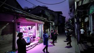 Residents wearing face masks dance at an old residential community blocked by barriers in Wuhan, in China’ Hubei province, the epicentre of China's coronavirus disease outbreak, on April 5.(Reuters Photo) Residents wearing face masks dance at an old residential community blocked by barriers in Wuhan, in China’ Hubei province, the epicentre of China's coronavirus disease outbreak, on April 5.(Reuters Photo)