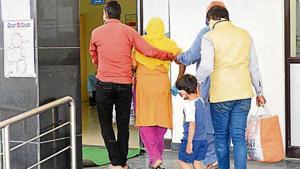 Relatives assist the fourth corona-positive case at RIMS on Monday.(Diwakar Prasad/HT photo) Relatives assist the fourth corona-positive case at RIMS on Monday.(Diwakar Prasad/HT photo)