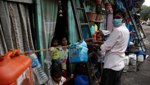 A man ties a rope outside his house to prevent his children from going outside and to stop people from coming to his home, after people in the area tested positive for the coronavirus disease Covid-19 in Dharavi, Mumbai, on April 6.(Reuters Photo) A man ties a rope outside his house to prevent his children from going outside and to stop people from coming to his home, after people in the area tested positive for the coronavirus disease Covid-19 in Dharavi, Mumbai, on April 6.(Reuters Photo)