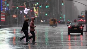 Times Square is quiet as people jog through a rain storm during the coronavirus pandemic in New York.(AP Photo) Times Square is quiet as people jog through a rain storm during the coronavirus pandemic in New York.(AP Photo)