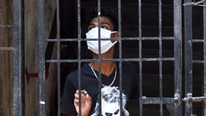 A boy seen wearing mask standing inside the gate at Grand Road during nation wide lockdown due to Covid-19 spread in Mumbai.(Satish Bate/HT Photo) A boy seen wearing mask standing inside the gate at Grand Road during nation wide lockdown due to Covid-19 spread in Mumbai.(Satish Bate/HT Photo)