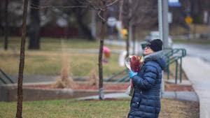 A woman prays as she leaves flowers outside Residence Herron, a senior's long-term care facility, following a number of deaths since the coronavirus disease outbreak, in the suburb of Dorval in Montreal Quebec, Canada on April 13.(Reuters Photo) A woman prays as she leaves flowers outside Residence Herron, a senior's long-term care facility, following a number of deaths since the coronavirus disease outbreak, in the suburb of Dorval in Montreal Quebec, Canada on April 13.(Reuters Photo)