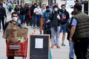 Shoppers keep a social distance during the coronavirus disease outbreak as they wait in line on the sidewalk outside a grocery store in Washington.(Reuters Photo) Shoppers keep a social distance during the coronavirus disease outbreak as they wait in line on the sidewalk outside a grocery store in Washington.(Reuters Photo)