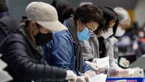 All voters were required to wear protective masks, clean their hands with sanitiser and don plastic gloves, and undergo temperature checks on arrival at the polling station.(Bloomberg file photo) All voters were required to wear protective masks, clean their hands with sanitiser and don plastic gloves, and undergo temperature checks on arrival at the polling station.(Bloomberg file photo)