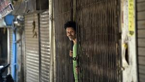 A man looks on while standing at the door of his house at J 4 Block of Khirki Extension in Khirki Village, one of the red zones now sealed, during lockdown against coronavirus, in New Delhi, India.(Sanjeev Verma/HT PHOTO) A man looks on while standing at the door of his house at J 4 Block of Khirki Extension in Khirki Village, one of the red zones now sealed, during lockdown against coronavirus, in New Delhi, India.(Sanjeev Verma/HT PHOTO)