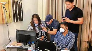 An employee of the call centre (far left) speaks to investigators at the Radisson in Gurugram’s Udyog Vihar.(Leena Dhankhar/HTphoto) An employee of the call centre (far left) speaks to investigators at the Radisson in Gurugram’s Udyog Vihar.(Leena Dhankhar/HTphoto)