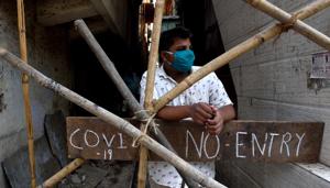 A mask wearing man standing near the No-Entry board at Shivaji Nagar, Mankhurd during the nationwide lockdown imposed in the wake of the coronavirus pandemic in Mumbai.(Satish Bate/HT Photo) A mask wearing man standing near the No-Entry board at Shivaji Nagar, Mankhurd during the nationwide lockdown imposed in the wake of the coronavirus pandemic in Mumbai.(Satish Bate/HT Photo)