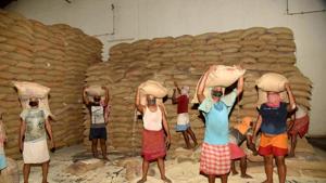 Labours carry sacks of rice from a Food Corporation of India (FCI) warehouse to trucks for transportation for distribution in villages, during lockdown in Patna.(Santosh Kumar /HT PHOTO)