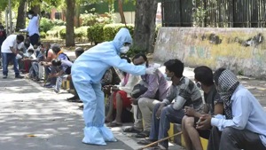 People are thermal screened and sensitized about the coronavirus by workers in PPE.(Sonu Mehta/ HT Photo) People are thermal screened and sensitized about the coronavirus by workers in PPE.(Sonu Mehta/ HT Photo)