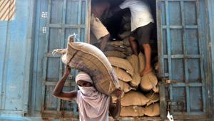 A labourer carries sacks containing rice grain to store at a Food Corporation of India (FCI) warehouse during lockdown in Jammu, on Saturday, April 18, 2020.(Photo by Nitin Kanotra / Hindustan Times) A labourer carries sacks containing rice grain to store at a Food Corporation of India (FCI) warehouse during lockdown in Jammu, on Saturday, April 18, 2020.(Photo by Nitin Kanotra / Hindustan Times)