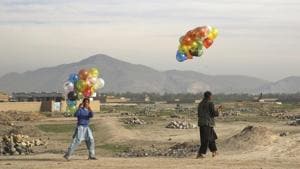 Vendors walk with colored balloons for sale on the outskirts of Kabul, Afghanistan, Wednesday, April 22, 2020.(AP) Vendors walk with colored balloons for sale on the outskirts of Kabul, Afghanistan, Wednesday, April 22, 2020.(AP)