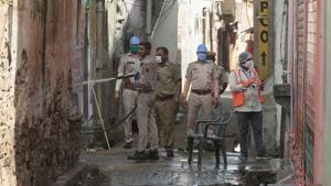 Police and health officials sanitize a congested lane after a resident tested positive for Covid-19, outside Ramganj locality in Jaipur on Sunday.(Himanshu Vyas/HT PHOTO) Police and health officials sanitize a congested lane after a resident tested positive for Covid-19, outside Ramganj locality in Jaipur on Sunday.(Himanshu Vyas/HT PHOTO)