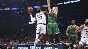 Los Angeles Lakers forward LeBron James (23) passes the ball under pressure from Boston Celtics center Daniel Theis (27) in the first half at Staples Center.(USA TODAY Sports) Los Angeles Lakers forward LeBron James (23) passes the ball under pressure from Boston Celtics center Daniel Theis (27) in the first half at Staples Center.(USA TODAY Sports)