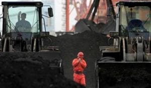 An employee walks between front-end loaders which are used to move coal imported from North Korea at Dandong port in the Chinese border city of Dandong, Liaoning province.(REUTERS FILE) An employee walks between front-end loaders which are used to move coal imported from North Korea at Dandong port in the Chinese border city of Dandong, Liaoning province.(REUTERS FILE)