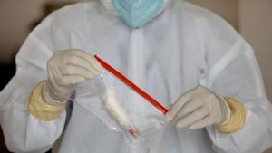 A doctor wearing a protective suit seals a bag containing a swab sample vial, at a testing center for Covid-19 in New Delhi.(REUTERS) A doctor wearing a protective suit seals a bag containing a swab sample vial, at a testing center for Covid-19 in New Delhi.(REUTERS)