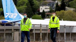 Boeing workers wear masks at the Boeing Renton Factory, where 737 MAX airliners are manufactured, as commercial airplane production resumes following a suspension of operations last month in response to the coronavirus pandemic.(Reuters File Photo) Boeing workers wear masks at the Boeing Renton Factory, where 737 MAX airliners are manufactured, as commercial airplane production resumes following a suspension of operations last month in response to the coronavirus pandemic.(Reuters File Photo)