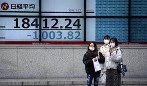 Women stand in front of at an electronic stock board showing Japan's Nikkei 225 index at a securities firm in Tokyo Thursday, March 12, 2020.(AP) Women stand in front of at an electronic stock board showing Japan's Nikkei 225 index at a securities firm in Tokyo Thursday, March 12, 2020.(AP)