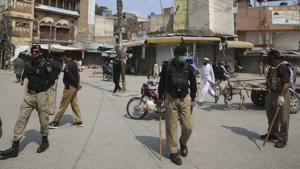 Police officers patrol a market during Covid-19 lockdown, in Pakistan’s Peshawar.(AP Photo) Police officers patrol a market during Covid-19 lockdown, in Pakistan’s Peshawar.(AP Photo)