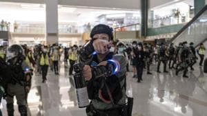 A riot police officer holds a pepper spray aerosol as crowds are dispersed during a protest inside the New Town Plaza shopping mall in the Shatin district of Hong Kong, China.(Bloomberg) A riot police officer holds a pepper spray aerosol as crowds are dispersed during a protest inside the New Town Plaza shopping mall in the Shatin district of Hong Kong, China.(Bloomberg)