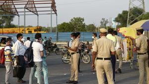 Gurugram Police personnel screen commuters at the Delhi Gurugram Border (Sirhaul border) on NH 48 during lockdown in the wake of coronavirus, in Gurugram.